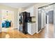 Kitchen featuring stainless steel refrigerator and hardwood floors leading to the dining and living spaces at 6834 Fireside Ln, South Fulton, GA 30349