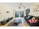 Living room with hardwood floors, stylish furniture, and large windows at 6834 Fireside Ln, South Fulton, GA 30349