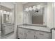 Bathroom with double vanity, granite counters, and modern lighting fixtures at 855 Riverbend Drive Sw, Lilburn, GA 30047