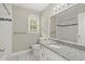 Updated bathroom featuring granite countertop, tile flooring, and shower-tub combo at 855 Riverbend Sw Dr, Lilburn, GA 30047