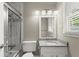 Updated bathroom featuring tiled shower-tub, granite countertop, and modern vanity at 855 Riverbend Drive Sw, Lilburn, GA 30047