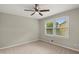 Bedroom with a ceiling fan and a large window, providing ample natural light at 855 Riverbend Sw Dr, Lilburn, GA 30047