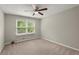 Cozy bedroom with natural light, neutral carpet, and double window at 855 Riverbend Sw Dr, Lilburn, GA 30047