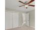 This bedroom features a ceiling fan and a large double-door closet at 855 Riverbend Sw Dr, Lilburn, GA 30047
