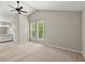 Large bedroom with vaulted ceiling, two windows, ceiling fan, and connecting bathroom at 855 Riverbend Sw Dr, Lilburn, GA 30047