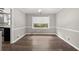 Dining area with wood floors, classic light fixture, and adjacent to the kitchen at 855 Riverbend Sw Dr, Lilburn, GA 30047