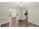 Dining room showcasing wood floors, crown molding, and views into other rooms at 855 Riverbend Sw Dr, Lilburn, GA 30047