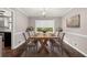 Formal dining room with wooden table, seating for six, and stylish decor at 855 Riverbend Sw Dr, Lilburn, GA 30047