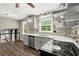 Modern kitchen featuring updated appliances, sleek countertops, and tile backsplash at 855 Riverbend Sw Dr, Lilburn, GA 30047