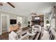 Spacious living room with hardwood floors, fireplace, built-in shelving, and two ceiling fans at 855 Riverbend Sw Dr, Lilburn, GA 30047
