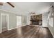 Bright living room with a fireplace, built-in shelves, hardwood floors, and open space at 855 Riverbend Sw Dr, Lilburn, GA 30047