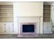 Living room fireplace with built-in shelving and hardwood floors at 134 Amherst Nw Pl, Atlanta, GA 30327