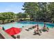 Community pool with lounge chairs, umbrellas, and tables at 134 Amherst Nw Pl, Atlanta, GA 30327