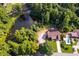 Aerial view showing house, private pond, and surrounding trees at 144 Bobs Sw Dr, Mableton, GA 30126