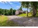 House exterior view, gravel driveway and lush landscaping at 144 Bobs Sw Dr, Mableton, GA 30126