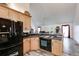 Kitchen with light wood cabinets, black appliances, and breakfast bar at 144 Bobs Sw Dr, Mableton, GA 30126