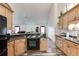 Kitchen with light wood cabinets, black appliances, and breakfast bar at 144 Bobs Sw Dr, Mableton, GA 30126