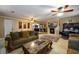 Spacious living room with a marble-top coffee table, comfortable seating, and a view of the kitchen at 3241 Briscoe Rd, Loganville, GA 30052