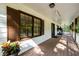 Long wooden front porch with brown shutters and entry door at 3241 Briscoe Rd, Loganville, GA 30052