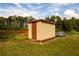 Tan colored storage shed in backyard at 3241 Briscoe Rd, Loganville, GA 30052