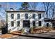 Renovated white brick home with black windows and modern entryway at 7715 Ryefield Dr, Sandy Springs, GA 30350