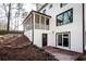 White brick house with screened porch and patio at 7715 Ryefield Dr, Sandy Springs, GA 30350