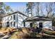 White brick house with black windows, landscaping, and a circular fountain at 7715 Ryefield Dr, Sandy Springs, GA 30350