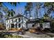 Two-story white brick house with black windows and a long driveway at 7715 Ryefield Dr, Sandy Springs, GA 30350