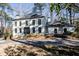 Two-story white brick house with black windows and a gravel driveway at 7715 Ryefield Dr, Sandy Springs, GA 30350