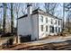 White brick house with black windows and a wooden fence at 7715 Ryefield Dr, Sandy Springs, GA 30350