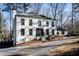 Two story white brick house with black windows and a long driveway at 7715 Ryefield Dr, Sandy Springs, GA 30350