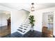 Elegant staircase with dark wood steps and white railings at 7715 Ryefield Dr, Sandy Springs, GA 30350