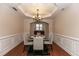 Elegant dining room with hardwood floors, tray ceiling, and chandelier at 1300 Scenic View Trce, Lawrenceville, GA 30044