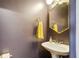 Stylish powder room with modern fixtures, dark walls and a unique gold mirror at 209 16Th Nw St # 6, Atlanta, GA 30363