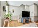 Living room with TV, stylish blue cabinet and hardwood floors, flooded with natural light at 209 16Th Nw St # 6, Atlanta, GA 30363