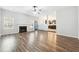 Spacious living room features hardwood floors, fireplace, and kitchen view at 3736 Busker Mill Ln, Ellenwood, GA 30294