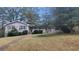 Brick ranch house with covered porch, landscaped yard, and walkway at 3873 Jane Marie Ln, Decatur, GA 30035