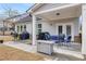 Covered patio with seating area, grill, and storage at 91 N. Harris St, Buford, GA 30518