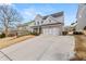 Two-story home with gray siding, brick accents, and a three-car garage at 91 Harris St, Buford, GA 30518