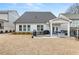 Back of house showing patio, yard, and landscaping at 91 Harris St, Buford, GA 30518