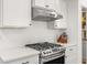 Modern kitchen features stainless steel range and white cabinetry at 91 N. Harris St, Buford, GA 30518