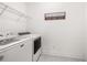 Laundry room with washer, dryer, and shelving at 91 Harris St, Buford, GA 30518