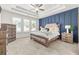 Large main bedroom with blue accent wall and plush bed at 91 N. Harris St, Buford, GA 30518