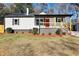 Newly renovated house featuring a modern exterior, landscaped lawn, and a welcoming front porch at 2007 North Nw Ave, Atlanta, GA 30318