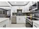 Updated kitchen boasting white cabinets, stainless steel appliances, and a stylish backsplash at 2007 North Nw Ave, Atlanta, GA 30318