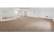 Bright bonus room with brown carpet, high ceilings, and storage at 3182 Henderson Walk, Atlanta, GA 30340