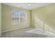 Bright bedroom with carpet flooring and large window at 45 Kendall Ln, Covington, GA 30014