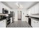 Modern kitchen with stainless steel appliances and patterned floor at 45 Kendall Ln, Covington, GA 30014