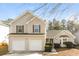 Two-story house with beige siding and two car garage at 4905 Bridle Point Pkwy, Snellville, GA 30039