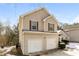 Two-story house with double garage and neutral siding at 4905 Bridle Point Pkwy, Snellville, GA 30039